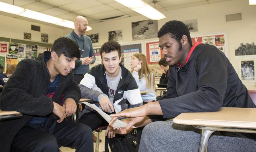Students prepare in groups for a debate. 