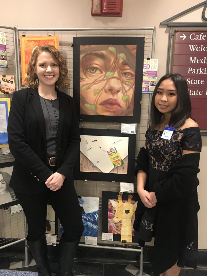 Art teacher Ms. Hughes poses with Denise Dacaney and the award-winning artwork