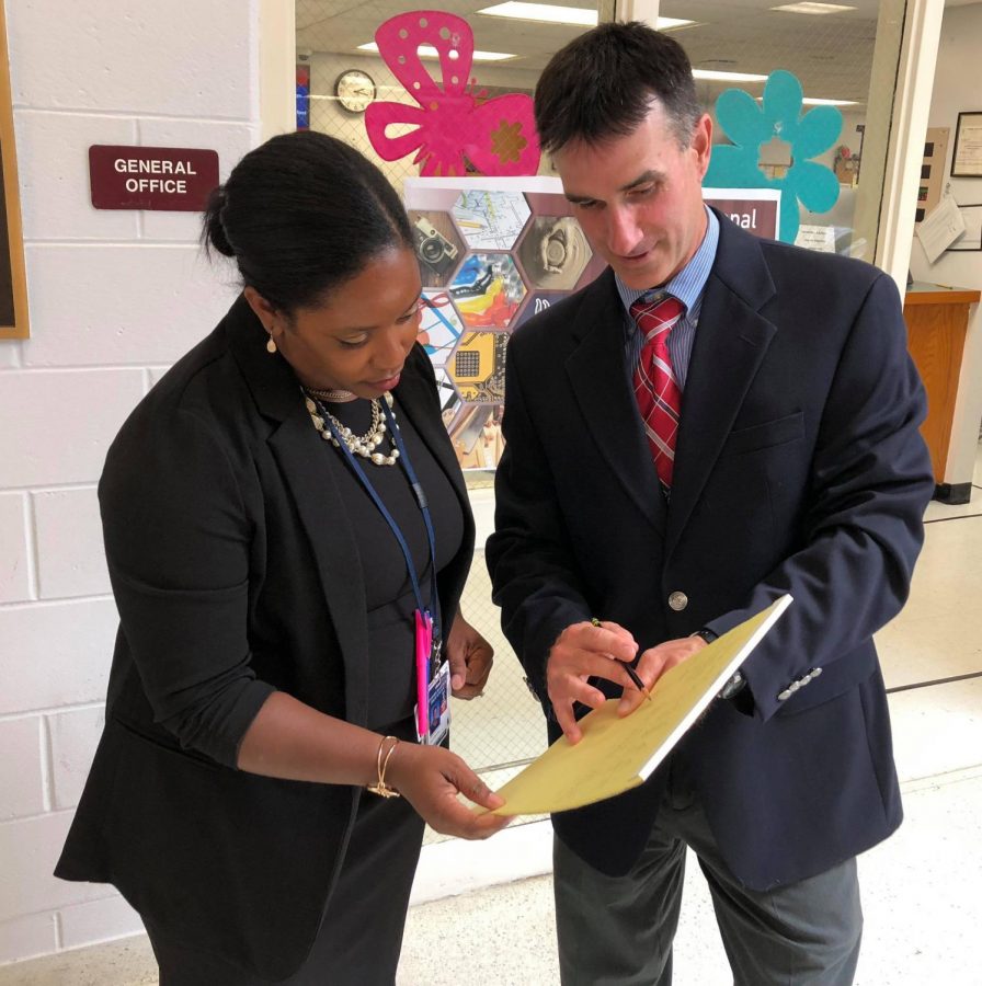 Mrs. Holloway-Taluy confers with fellow VP Steve Young. 
