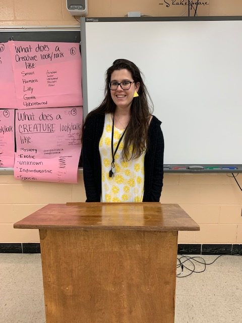 Ms. Snuffin teaches behind her podium. 