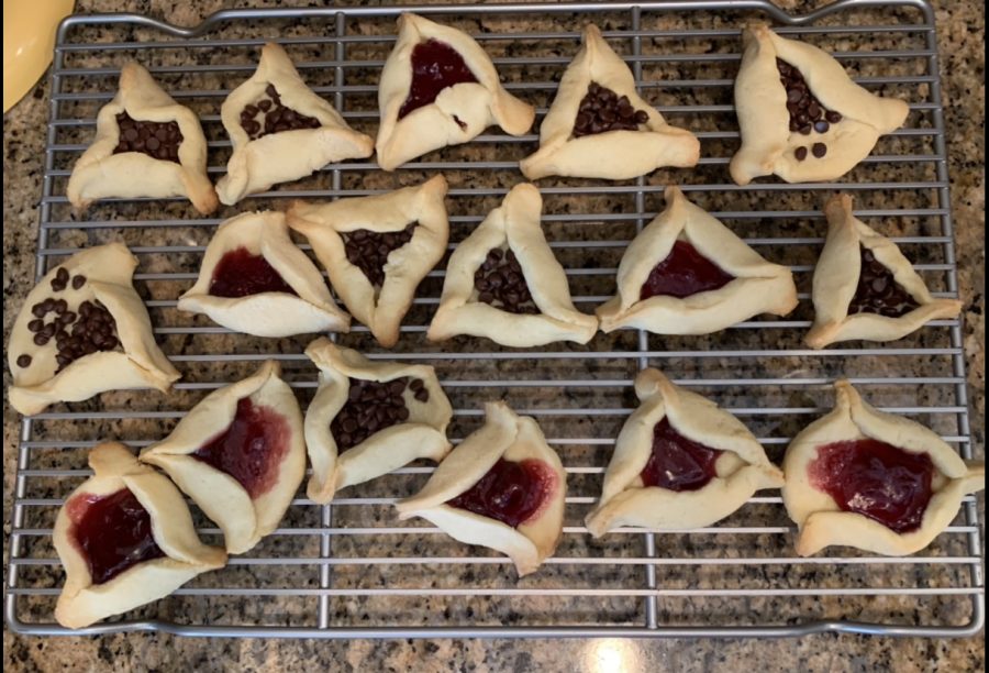 Hamantaschen are a traditional pastry for Purim that represent Hamans hat. Two popular flavors, pictured here, are cherry and chocolate chip. 