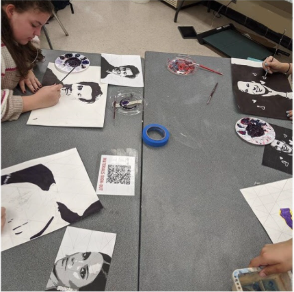 Art students work on their portrait pieces.