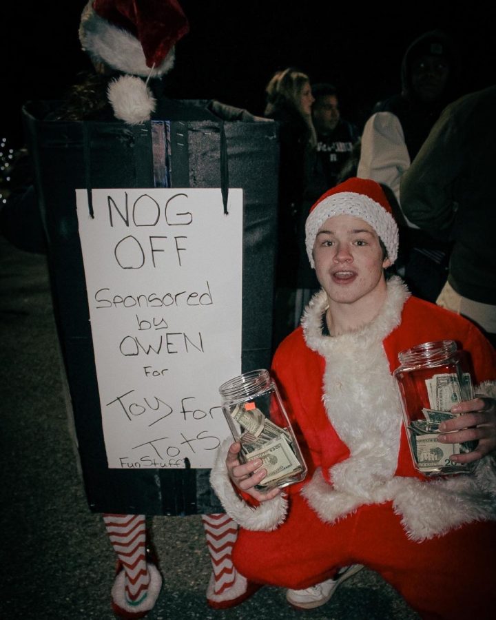 Owen Donahue wears his Santa Suit and crouches next to the fundraising bin after encouraging people to donate to the cause. Pictured by Wesley Andrews. 