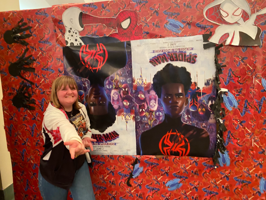 Swift poses with the AMC theater’s posters for Across the Spider-Verse, looking dorky as ever in her Spidey swag.