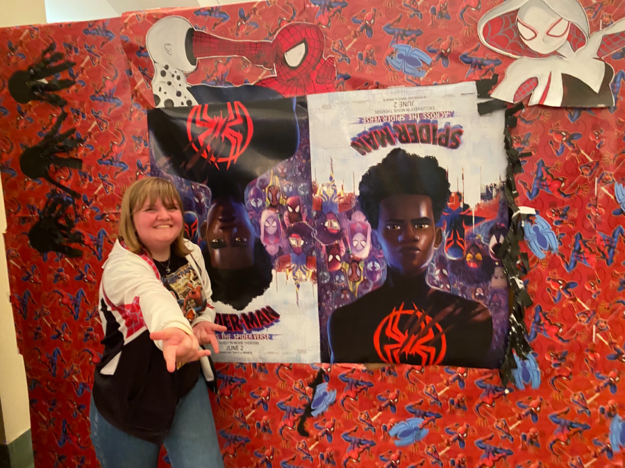 Swift+poses+with+the+AMC+theater%E2%80%99s+posters+for+Across+the+Spider-Verse%2C+looking+dorky+as+ever+in+her+Spidey+swag.