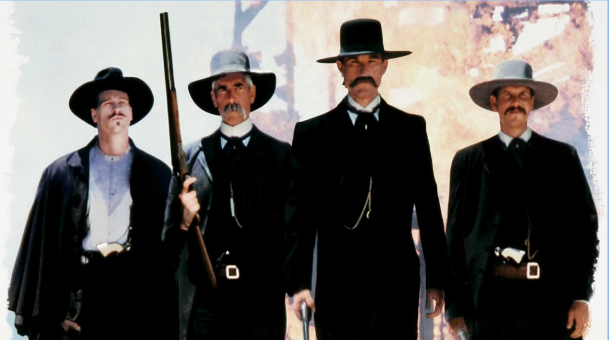Wyatt Earp (third from the right) with his two brothers (on both side of him) and Doc Holiday (far left). The group is walking toward the O.K Corral, where the famous shootout with the Cowboys take place. 
